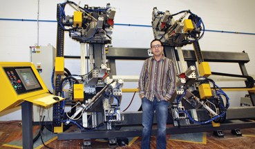 Dan Agius stands in front of Modern's four-point welder used in assembling window frames
